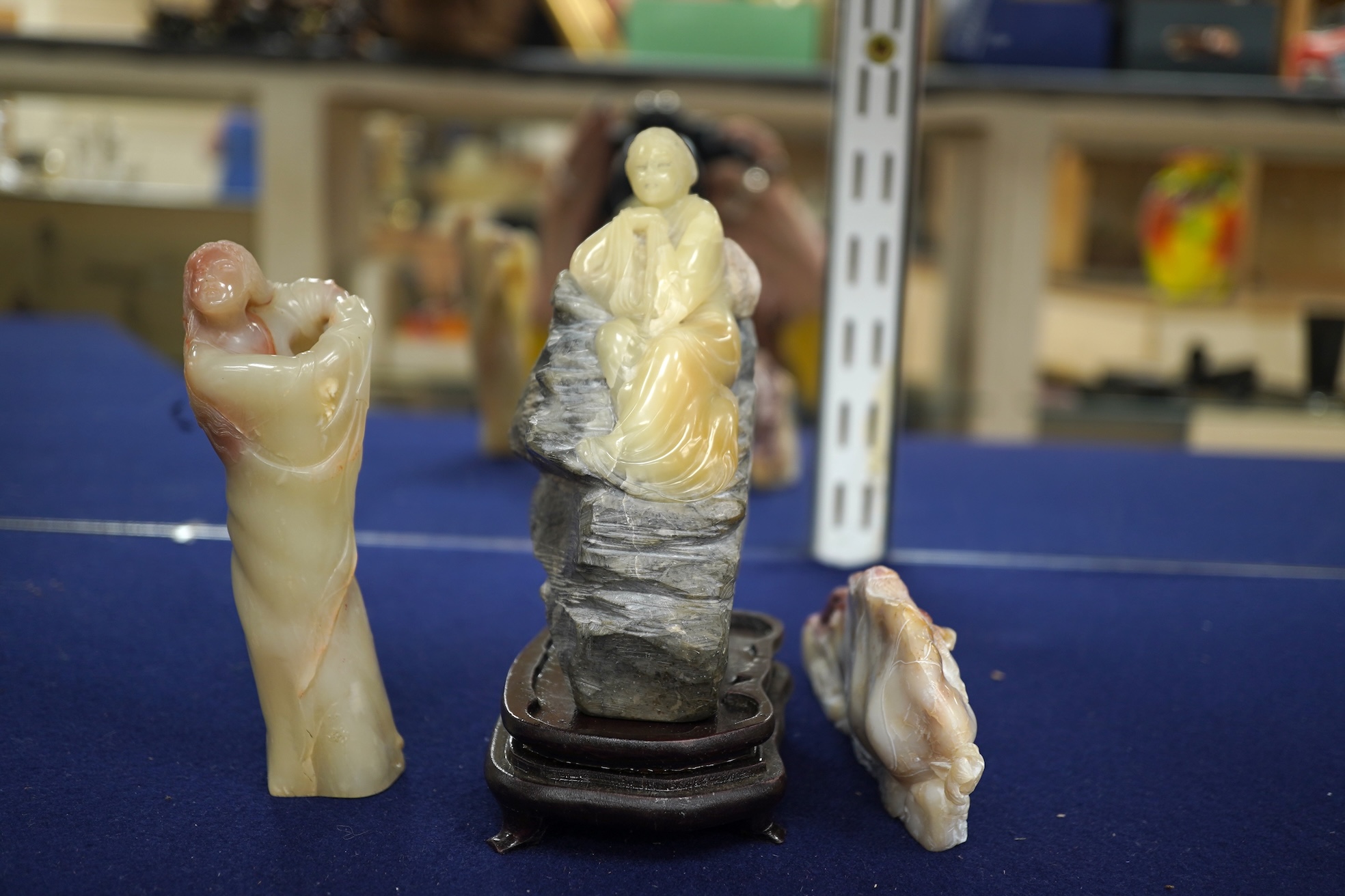 Three Chinese Shoushan stone figures of ladies and an associated stand, tallest 14cm